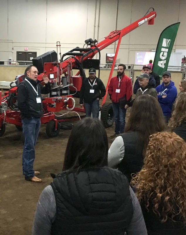 Blake Taylor, territory sales representative with AGI speaks to attendees of a Bayer Crop Science trade show at the Calnash Ag Event Centre Feb. 21. The trade show is about working closely with seed science while also working with industry partners.                                Photo by Jeffrey Heyden-Kaye