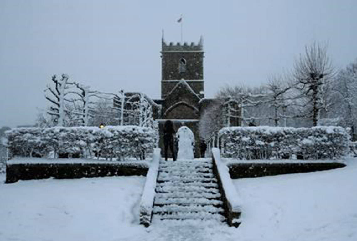 FILE - In this file photo dated Friday, Feb. 1, 2019, snow falls over St Peter’s Church in Bristol, south west England. The Church of England’s governing Synod on Friday Feb. 22, 2019, lifted a 400-year-old rule requiring all churches to hold services every Sunday, acknowledging the reality of shrinking congregations and overworked priests. (AP Photo/Matt Dunham, FILE)