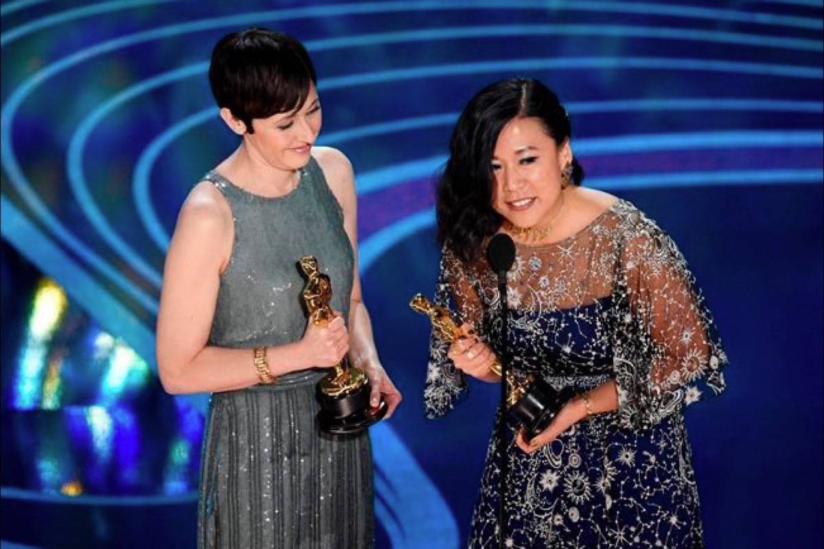 Becky Neiman-Cobb, left, and Domee Shi accept the award for best animated short for “Bao” at the Oscars on Sunday, Feb. 24, 2019, at the Dolby Theatre in Los Angeles. (Photo by Chris Pizzello/Invision/AP)