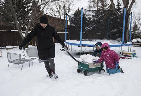 Vicki Maruyama plays with her daughters Akari, centre, and Arisa, left, in Edmonton on Wednesday, February 20, 2019. (THE CANADIAN PRESS/Jason Franson)