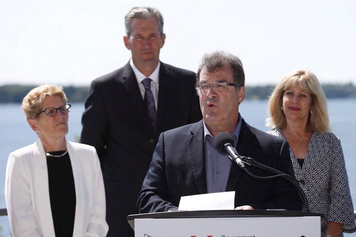 MP Bob Nault speaks at a announcement, as Ontario Premier Kathleen Wynne, Manitoba Premier Brian Pallister, and Cathy Cox, Manitoba Minister of Sustainable Development listen, in Kenora, Ont., on August 10, 2016. THE CANADIAN PRESS/John Woods