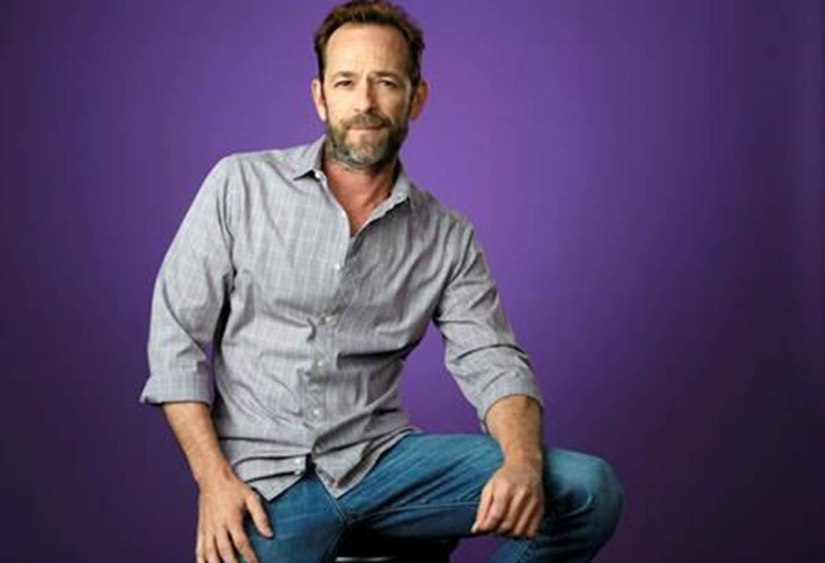 FILE - In this Aug. 6, 2018, file photo, Luke Perry, a cast member in the CW series “Riverdale,” poses for a portrait during the 2018 Television Critics Association Summer Press Tour in Beverly Hills, Calif. A publicist for the “Riverdale” and “Beverly Hills, 90210” star says the actor has been hospitalized. Arnold Robinson said the 52-year-old actor is “currently under observation” at the hospital. (Photo by Chris Pizzello/Invision/AP, File)