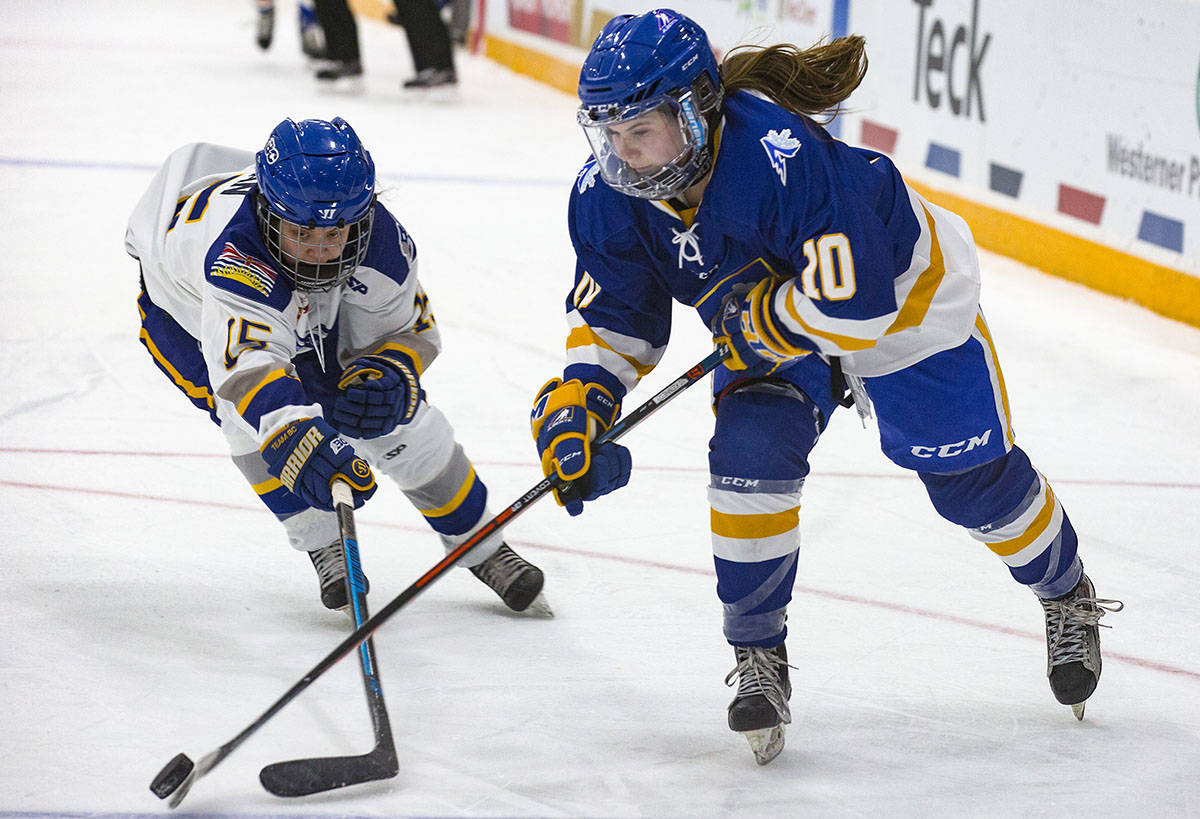 Katie Chan, left, and Bree Kennedy battle it out for the puck. Alberta edged B.C. in the semifinals 2-1 in OT Friday. Robin Grant/Red Deer Express