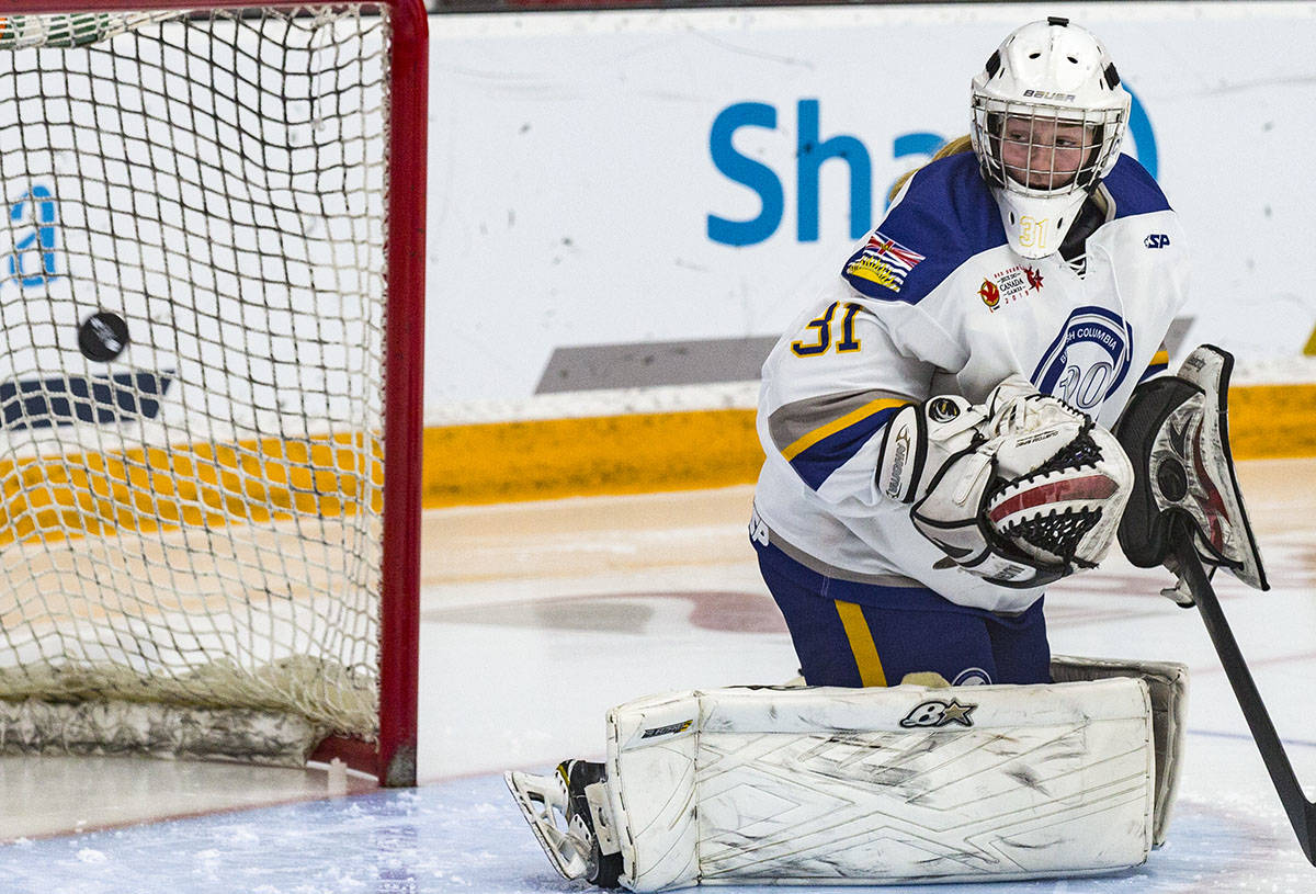 Team B.C. goalie Kiara Stecko watches as a puck flies into her net in the third period Friday. The goal, scored by Kassy Betinol, was Team Alberta’s first goal of the game. Alberta edged B.C. in the semifinals 2-1 in OT.