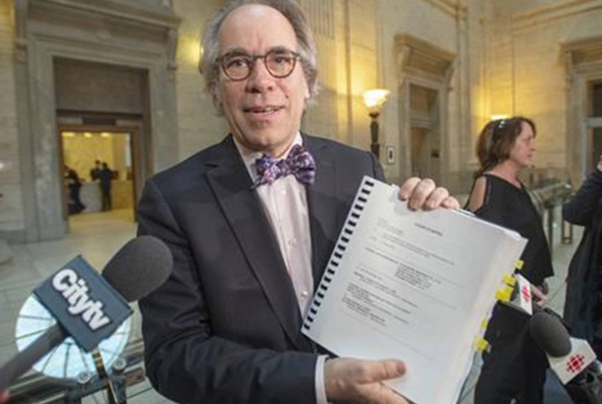 Andre Lesperance, one of the class action lawyers, holds up a copy of the decision by the Quebec Court of Appeal’s to uphold a Superior Court ruling in two class-action lawsuits against three tobacco companies, Friday, March 1, 2019 in Montreal. (Ryan Remiorz/The Canadian Press)