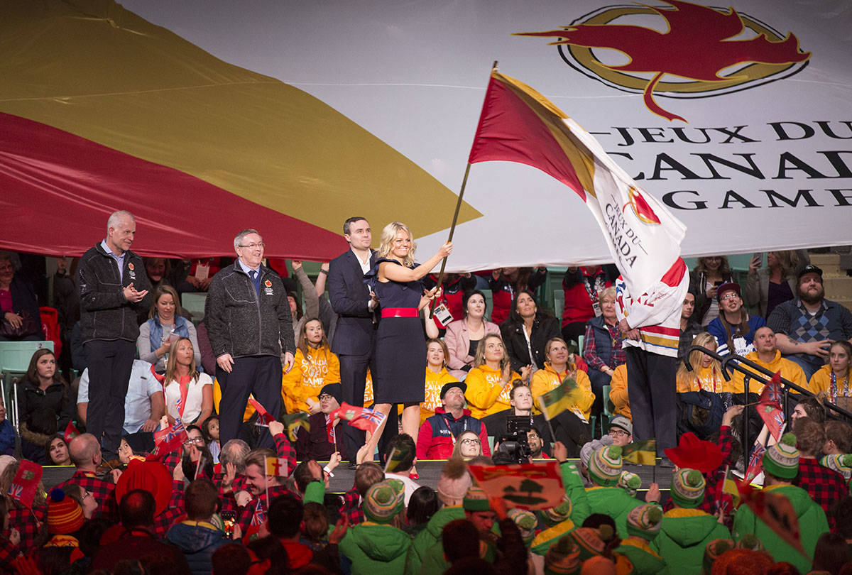 Red Deer Mayor Tara Veer waves the Canada Games flag before passing it to the Niagara Region official. The next Summer Games will take place in Ontario’s Niagara Region in 2021. Robin Grant/Red Deer Express