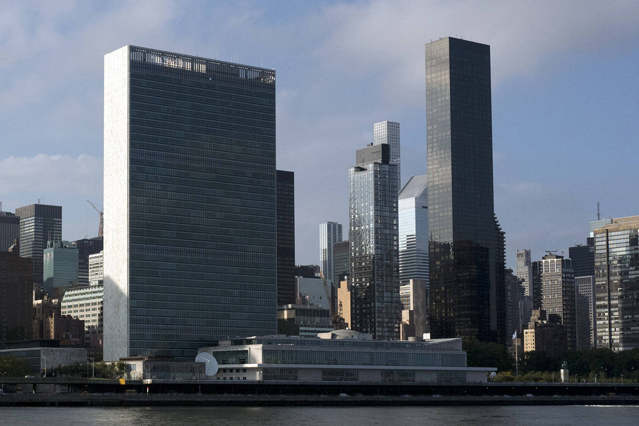 In this Oct. 10, 2018 photo, Trump World Tower, right, rises above the United Nations headquarters, center, in New York. (AP Photo/Mark Lennihan)