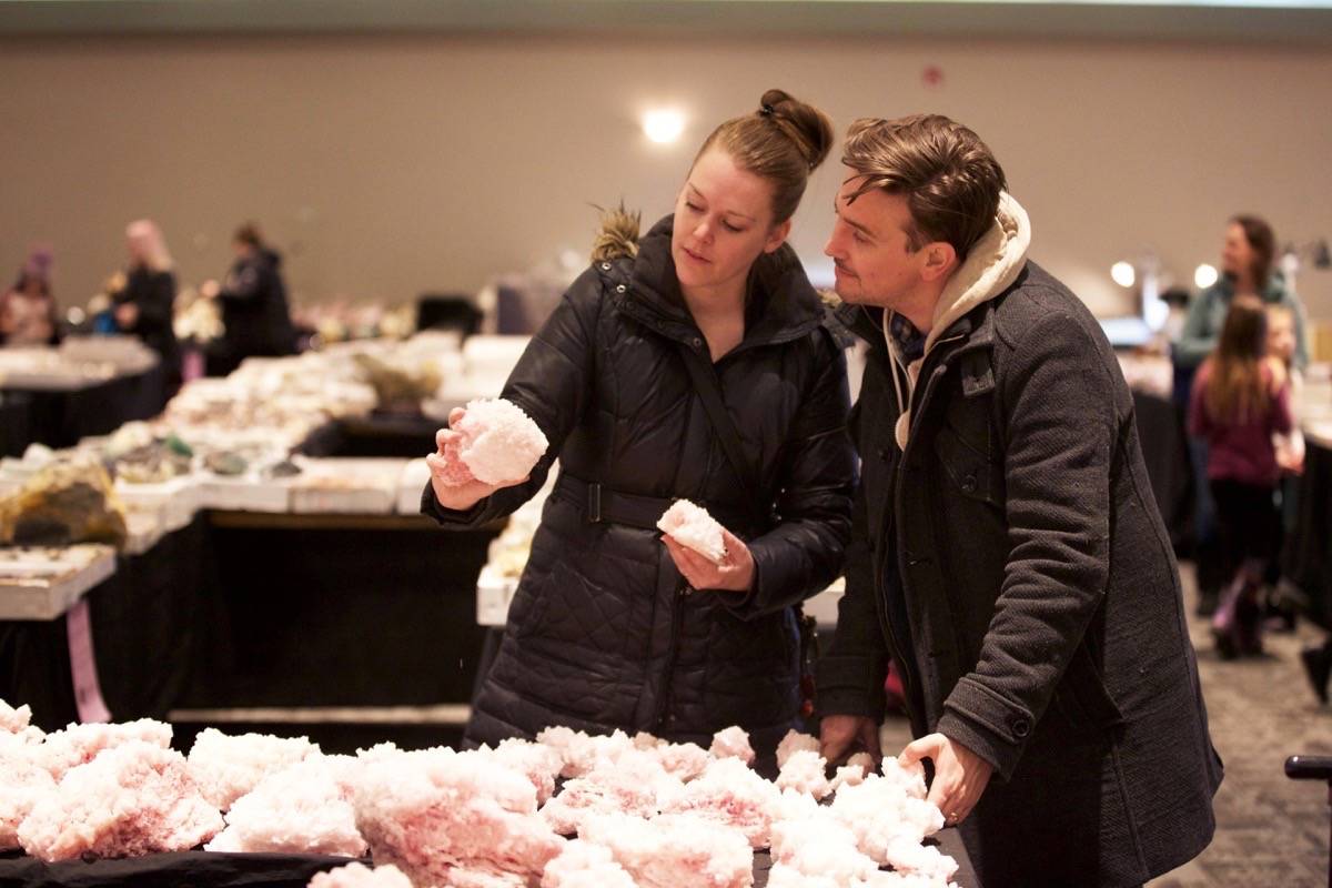 Hailey Nordstrom, left, and Galen Pendleton check out the pink halite on Wednesday, which Nordstrom says is very popular with her customers. She owns the online shop, Cave and Canyon. Robin Grant/Red Deer Express