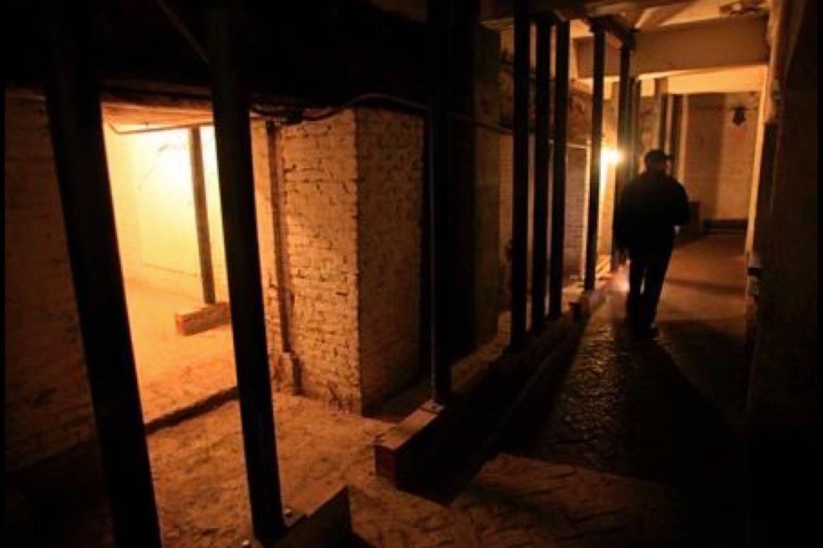 In this July 7, 2011, file photo, Jim Breeden of the Golden Gate National Parks Conservancy, walks through the dungeons below the main cell house during a night tour on Alcatraz Island in San Francisco. (AP Photo/Eric Risberg, File)