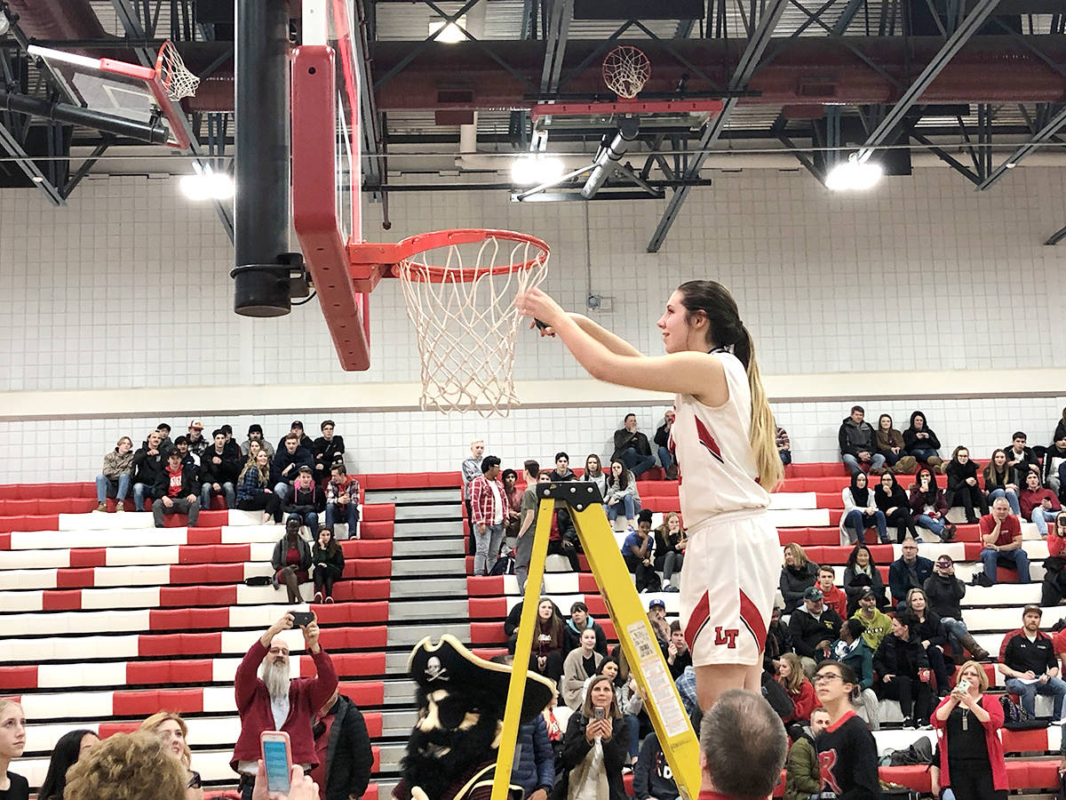 The Lindsay Thurber Raiders cut down the nets after winning Game 2 64-36 of their City Championship best-of-three series against the Hunting Hills Lightning. Todd Colin Vaughan