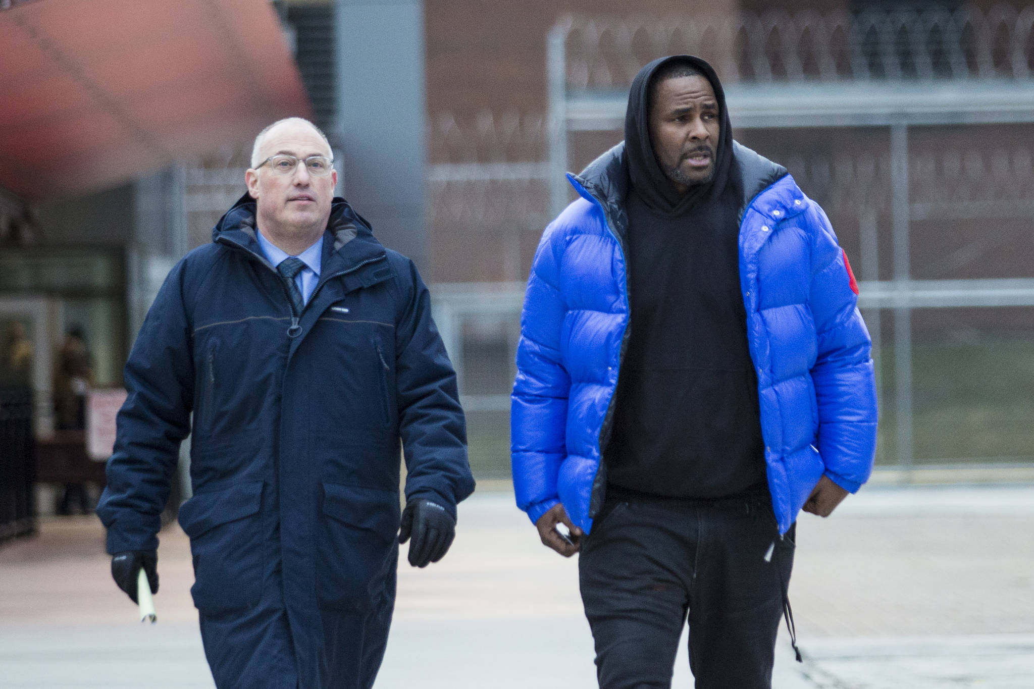 R. Kelly walks out of Cook County Jail with his defense attorney, Steve Greenberg, after posting $100,000 bail, Monday, Feb. 25, 2019 in Chicago. The R&B singer has entered a not guilty plea to all 10 counts of aggravated criminal sexual abuse. (Ashlee Rezin/Chicago Sun-Times via AP)