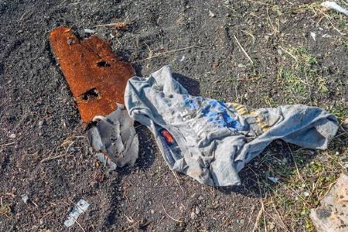 Clothing lies on the ground at the crash scene of an Ethiopian Airlines flight crash near Bishoftu, or Debre Zeit, south of Addis Ababa, Ethiopia, Monday, March 11, 2019. A spokesman says Ethiopian Airlines has grounded all its Boeing 737 Max 8 aircraft as a safety precaution, following the crash Sunday, of one of its planes in which 157 people are known to have died.(AP Photo/Mulugeta Ayene)