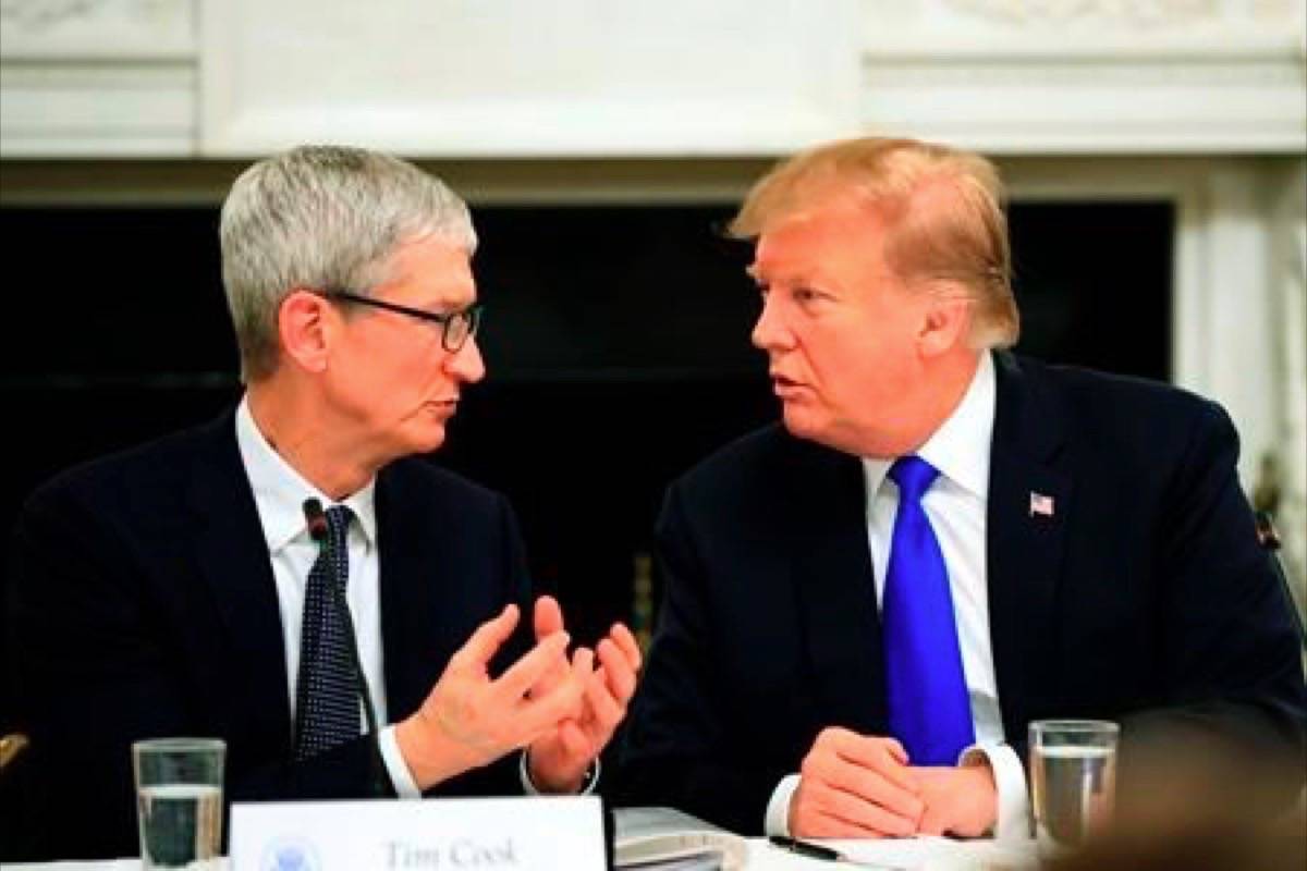 FILE - In this Wednesday, March 6, 2019 file photo, President Donald Trump talks to Apple Inc. CEO Tim Cook during the American Workforce Policy Advisory Board’s first meeting in the State Dining Room of the White House in Washington. (AP Photo/Manuel Balce Ceneta, File)