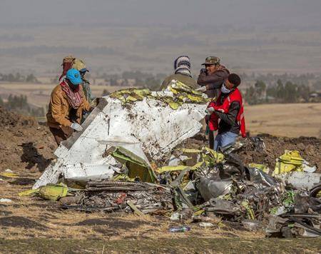 Rescuers work at the scene of an Ethiopian Airlines flight crash near Bishoftu, or Debre Zeit, south of Addis Ababa, Ethiopia, Monday, March 11, 2019. (AP Photo/Mulugeta Ayene)