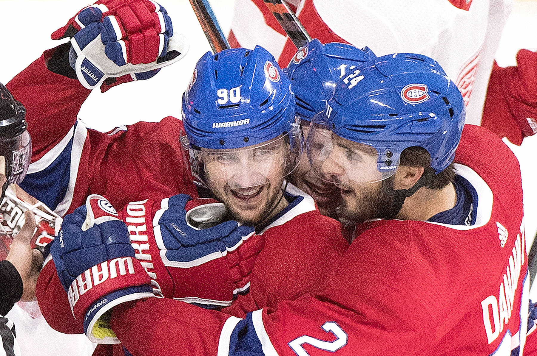 Montreal Canadiens’ Tomas Tatar, left, celebrates with teammate Phillip Danault, right, after scoring against the Detroit Red Wings during first period NHL hockey action in Montreal, Monday, Oct. 15, 2018. (Graham Hughes/The Canadian Press via AP)