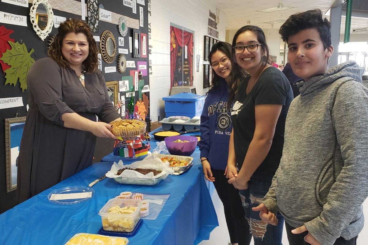 Left to Right: Mandy Reed (Vice-Principal) serving food to students Koussay Alai (Grade 11), Priya Bhatti (Grade 12) and Amanda Uy (Grade 12) at the food table. photo submitted
