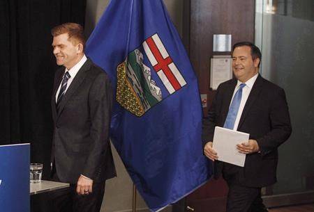 Then-Alberta Wildrose leader Brian Jean, left, walks in to a news conference to announce a unity deal between the two in Edmonton on Thursday, May 18, 2017. (THE CANADIAN PRESS/Jason Franson)
