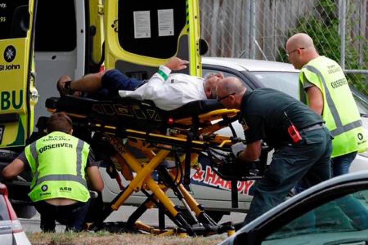 Ambulance staff take a man from outside a mosque in central Christchurch, New Zealand, Friday, March 15, 2019. A witness says many people have been killed in a mass shooting at a mosque in the New Zealand city of Christchurch. (AP Photo/Mark Baker)