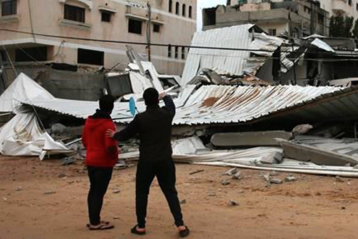 Palestinians inspect the damage of destroyed building belongs to Hamas ministry of prisoners hit by Israeli airstrikes in Gaza City, early Friday, Friday, March 15, 2019. Israeli warplanes attacked militant targets in the southern Gaza Strip early Friday in response to a rare rocket attack on the Israeli city of Tel Aviv, as the sides appeared to be hurtling toward a new round of violence. (AP Photo/Adel Hana)
