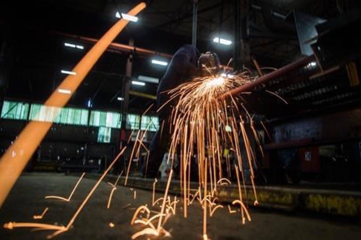 Fabricator Mike Caldarino uses a grinder on a steel stairs being manufactured for a high school in Redmond, Wash., at George Third & Son Steel Fabricators and Erectors, in Burnaby, B.C., on March 29, 2018. Statistics Canada says manufacturing sales climbed 1.0 per cent to $57.1 billion in January, boosted by higher sales in the food as well as the electrical equipment, appliance and component industries. The agency says the move higher followed three consecutive monthly decreases. THE CANADIAN PRESS/Darryl Dyck