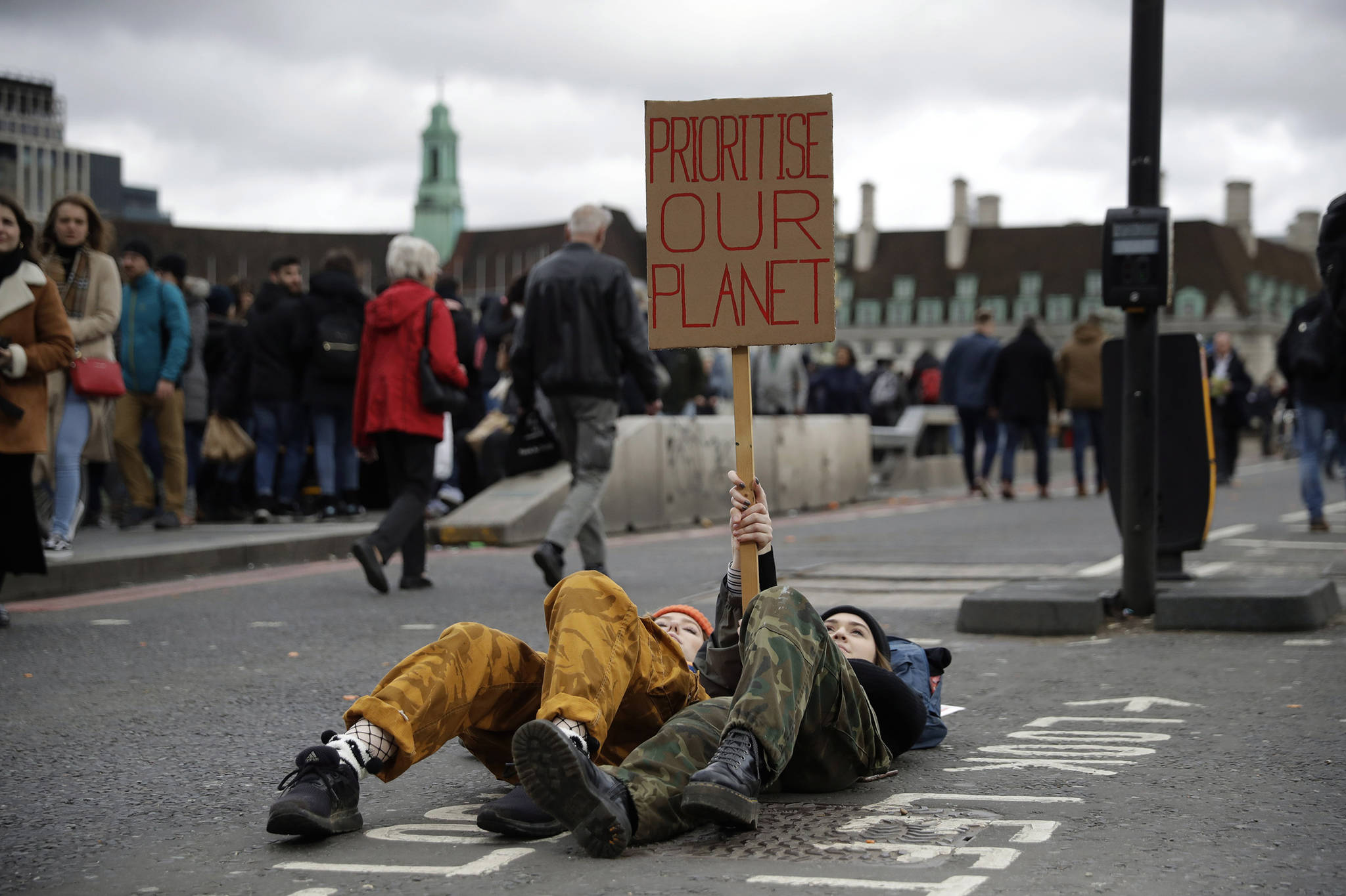 Youngsters lay down as they take part in a student climate protest at the bottom of Westminster Bridge in London, Friday, March 15, 2019. Students in more than 80 countries and territories worldwide plan to skip class Friday in protest over their governments’ failure to act against global warming. The coordinated ‘school strike’ was inspired by 16-year-old activist Greta Thunberg, who began holding solitary demonstrations outside the Swedish parliament last year. (AP Photo/Matt Dunham)