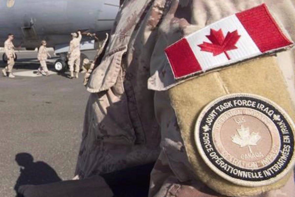 A member of the Canadian Forces stands on tarmac at the Canadian Forces base in the Persian Gulf, Sunday, February 19, 2017. Canada is extending its military missions in Ukraine and Iraq, both of which were due to expire at the end of the month. THE CANADIAN PRESS/Ryan Remiorz