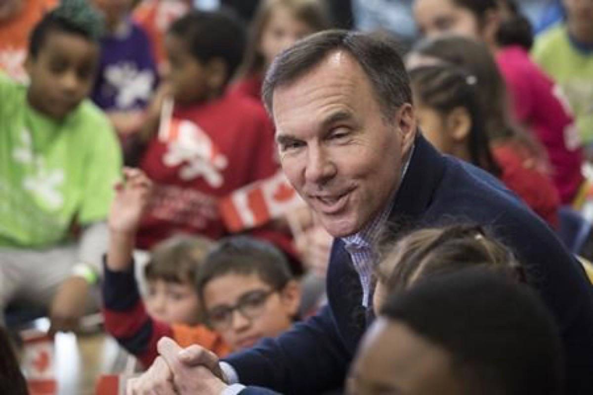 Federal Finance Minister Bill Morneau takes questions from children from the Toronto and Kiwanis Boys and Girls Club, after putting on his new budget shoes for a pre-budget photo opportunity in Toronto on Thursday, March 14, 2019. THE CANADIAN PRESS/Chris Young