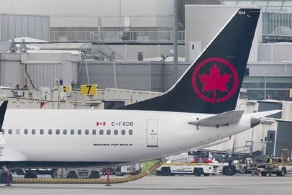An Air Canada Boeing 737 Max 8 aircraft is shown next to a gate at Trudeau Airport in Montreal, Wednesday, March 13, 2019. (THE CANADIAN PRESS/Graham Hughes)