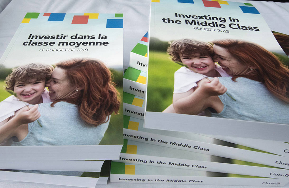 Copies of the 2019 budget booklet are stacked at a lockup session with experts and reporters in Ottawa on Tuesday, March 19, 2019. (Fred Chartrand/The Canadian Press)