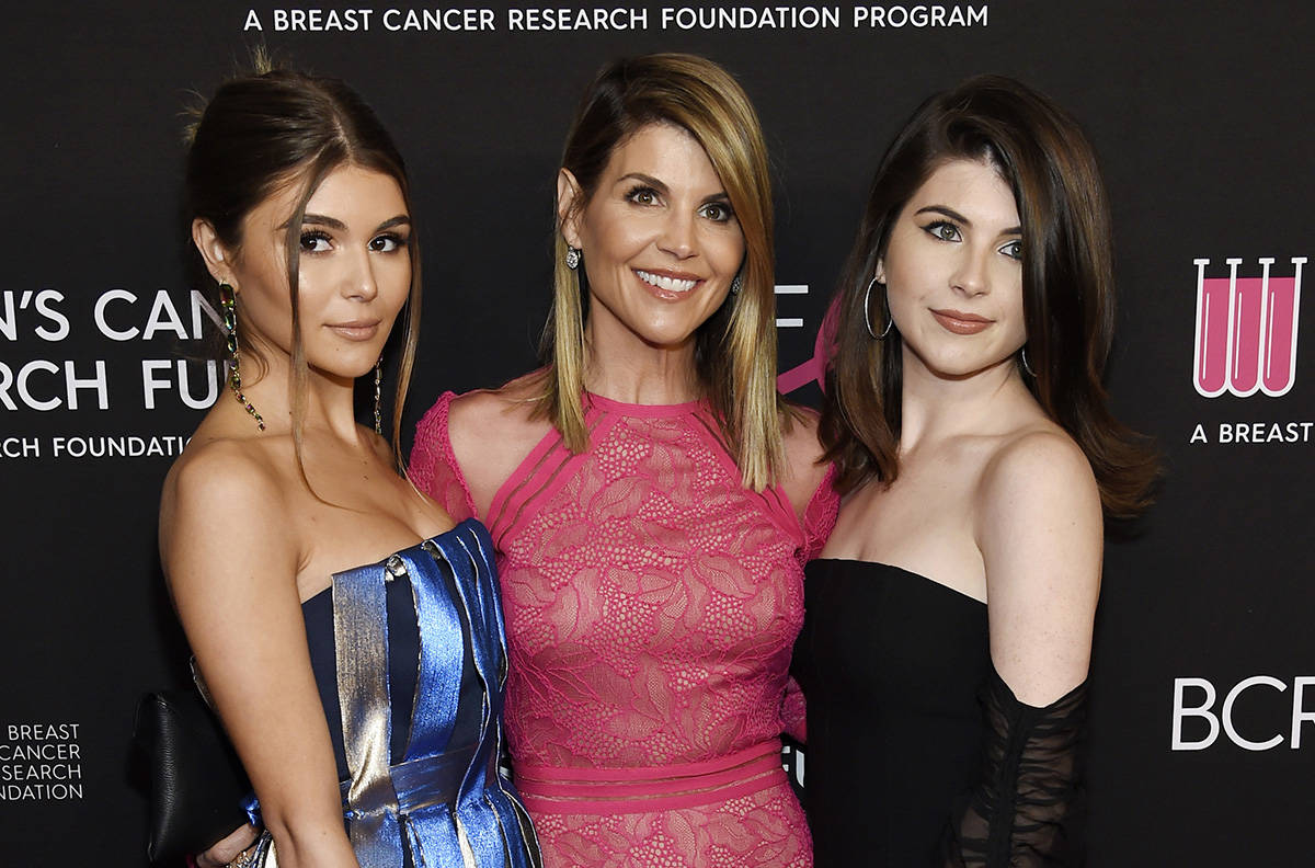 FILE - In this Feb. 28, 2019 file photo, actress Lori Loughlin, center, poses with daughters Olivia Jade Giannulli, left, and Isabella Rose Giannulli at the 2019 “An Unforgettable Evening” in Beverly Hills, Calif. (Photo by Chris Pizzello/Invision/AP, File)