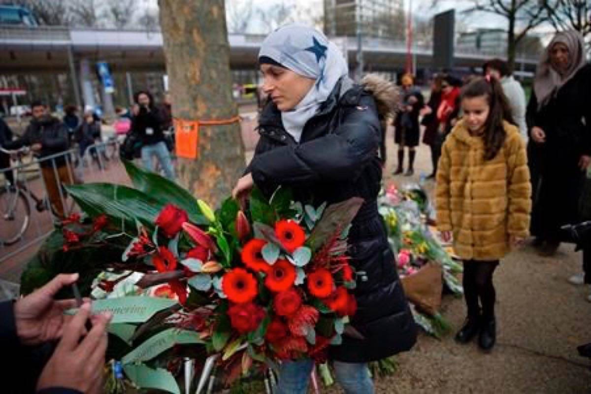 Women representing Utrecht’s Muslim community lay a wreath at a makeshift memorial for the victims of a shooting incident in a tram in Utrecht, Netherlands, Tuesday, March 19, 2019. A gunman killed three people and wounded others on a tram in the central Dutch city of Utrecht Monday March 18, 2019. (AP Photo/Peter Dejong)