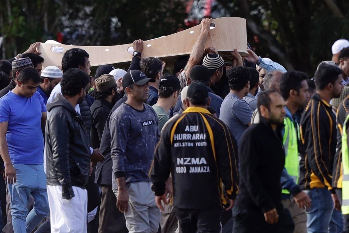 Mourners carry the body of a victim of the March 15 mosque shootings for a burial at the Memorial Park Cemetery in Christchurch, New Zealand, Wednesday, March 20, 2019. (AP Photo/Mark Baker)