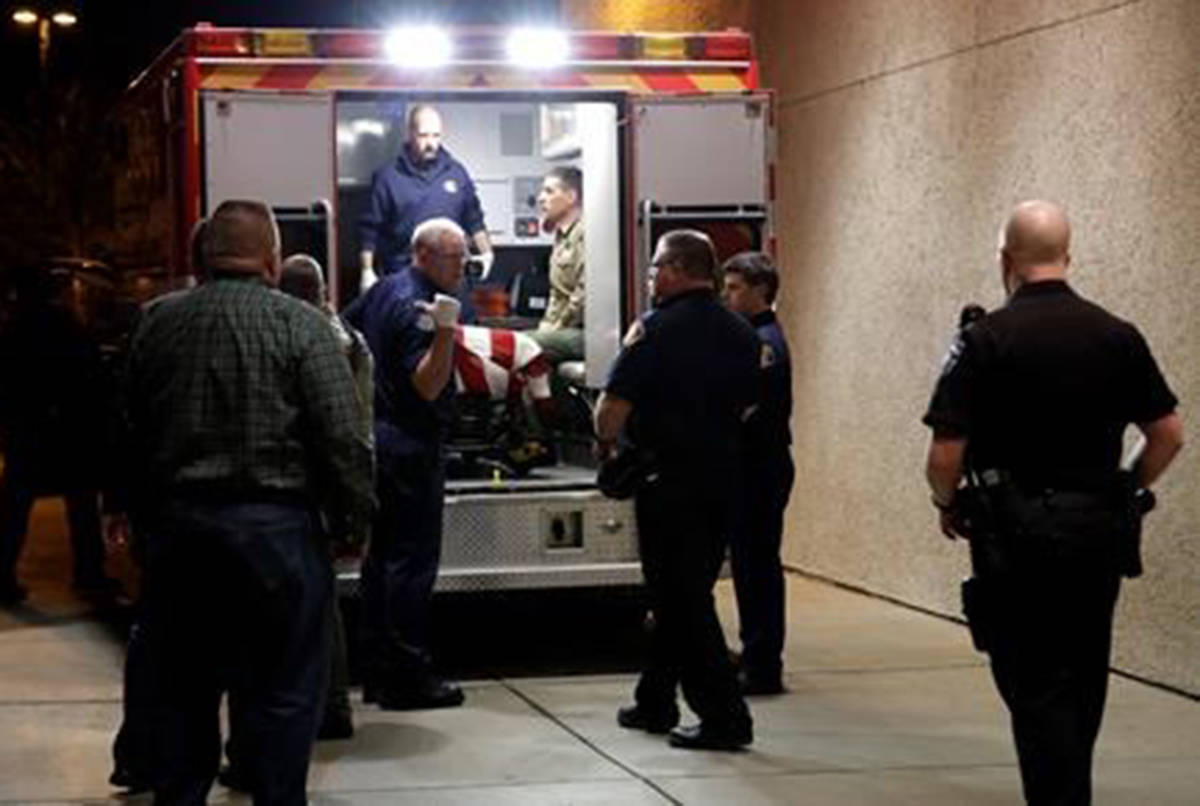 The body of a Kittitas County Sheriff’s deputy is draped with a U.S. flag as it is loaded into an ambulance for a procession away from Kittitas Valley Healthcare Hospital, in the early morning hours of Wednesday, March 20, 2019, in Ellensburg, Wash. Kittitas County Sheriff’s deputy was killed and a police officer was injured after an exchange of gunfire during an attempted traffic stop. (AP Photo/Ted S. Warren)