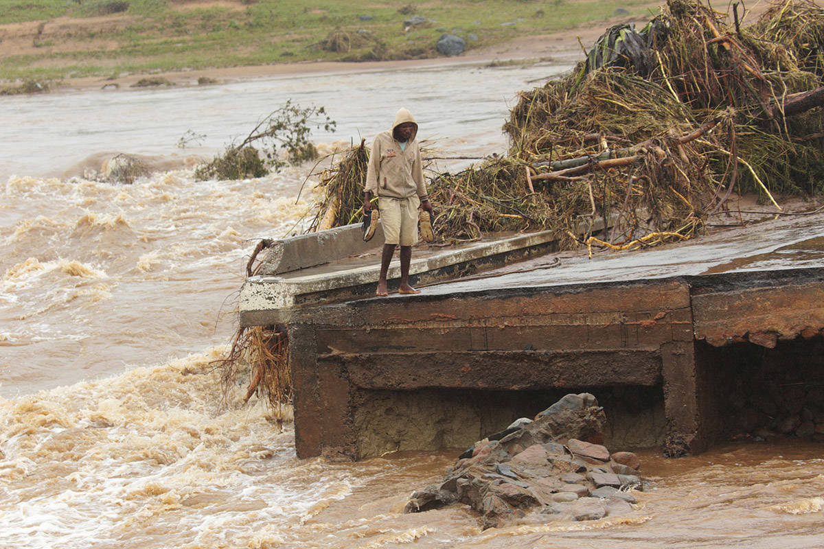 A man stands on the edge of a collapsed bridge in Chimanimani, about 600 kilometers southeast of Harare, Zimbabwe, Monday, March 18, 2019. (Tsvangirayi Mukwazhi/AP)