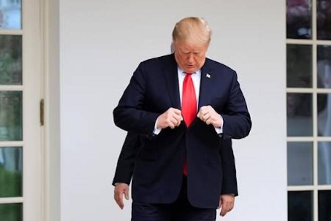 President Donald Trump followed by visiting Israeli Prime Minister Benjamin Netanyahu adjusts his suit as they walk along the Colonnade of the White House in Washington, Monday, March 25, 2019. (AP Photo/Manuel Balce Ceneta)