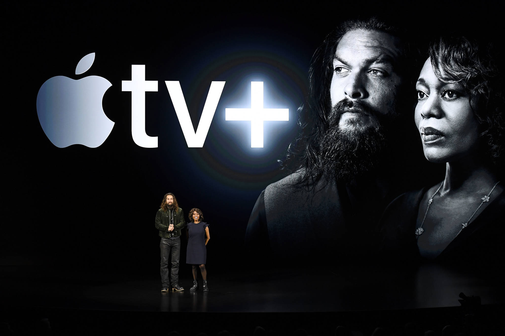 Actors Jason Momoa and Alfre Woodard, right, smile on stage during an Apple event at the Steve Jobs Theater in Cupertino, Calif., on Monday. MUST CREDIT: Bloomberg photo by David Paul Morris