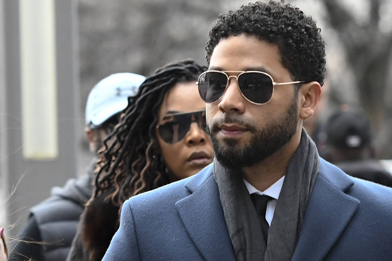 Empire actor Jussie Smollett, centre, arrives at the Leighton Criminal Court Building for his hearing on Thursday, March 14, 2019, in Chicago. (AP Photo/Matt Marton)