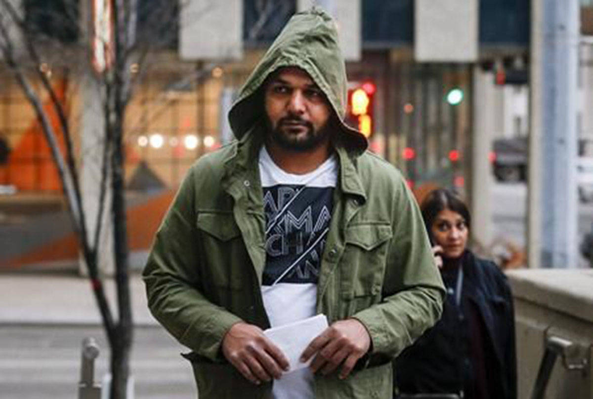 Sukhmander Singh, owner of the trucking company involved in the Humboldt Broncos bus crash, arrives at court to face non-compliance charges under federal and provincial safety regulations in Calgary on November 9, 2018. (Jeff McIntosh/The Canadian Press)