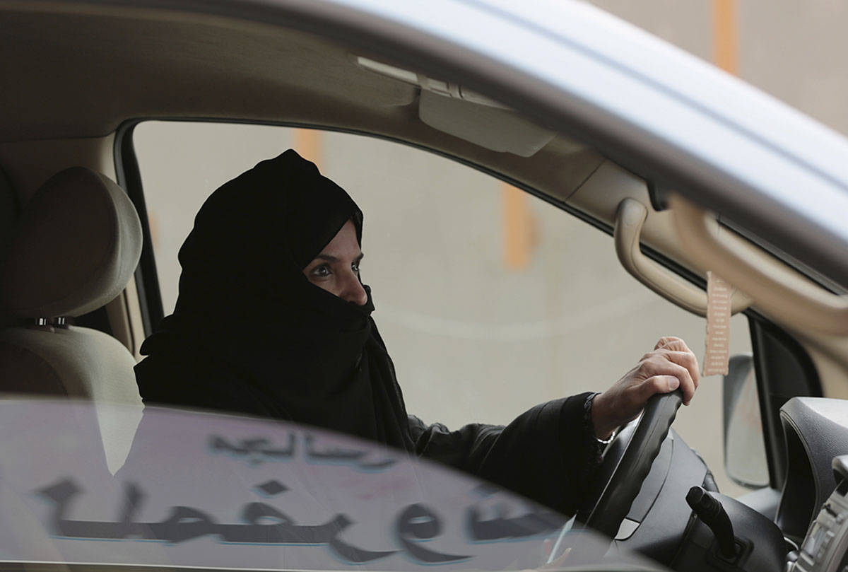 FILE - In this March 29, 2014 file photo, Aziza al-Yousef drives a car on a highway in Riyadh, Saudi Arabia, as part of a campaign to defy Saudi Arabia’s then ban on women driving. Saudi women’s rights activists, including al-Yousef, are expected to appear before a judge Wednesday, March 27, 2019, on charges that include speaking to foreign journalists. (AP Photo/Hasan Jamali, File)