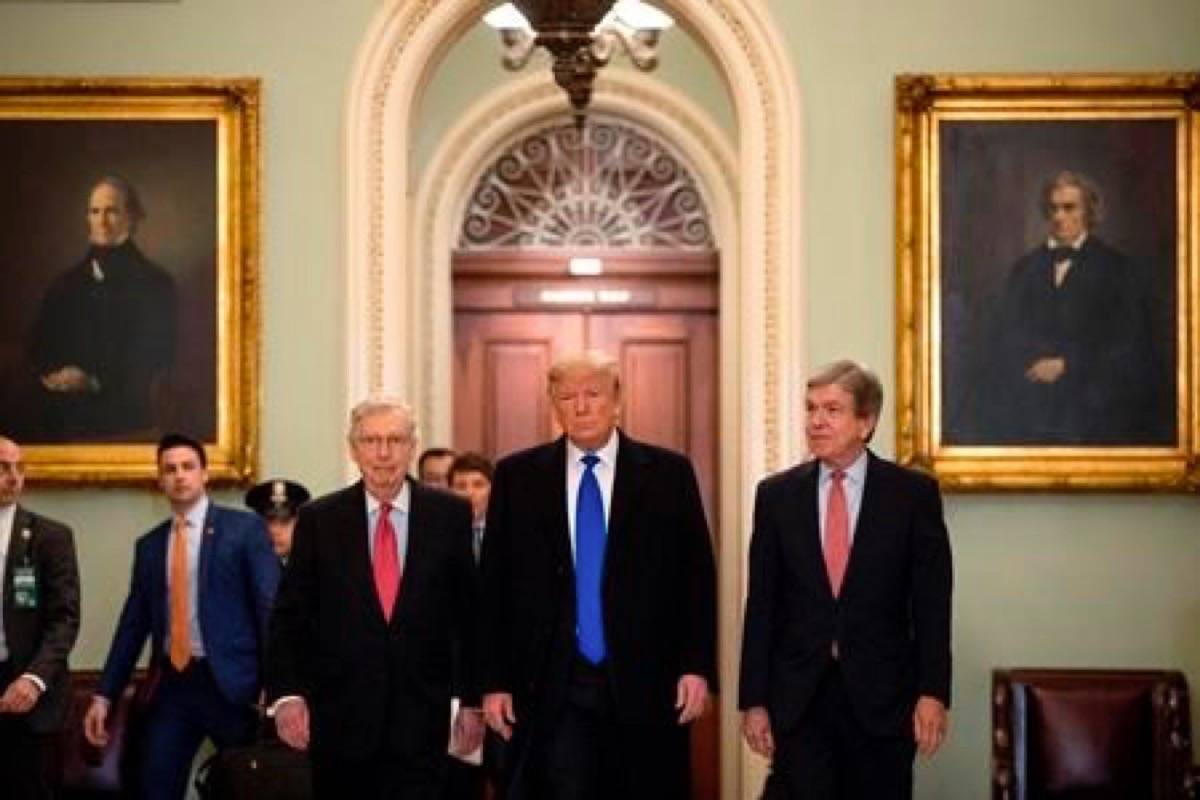 President Donald Trump accompanied by Senate Majority Leader Mitch McConnell of Ky., left, and Sen. Roy Blunt, R-Mo., right, arrives for a Senate Republican policy lunch on Capitol Hill in Washington, Tuesday, March 26, 2019. (AP Photo/Andrew Harnik)