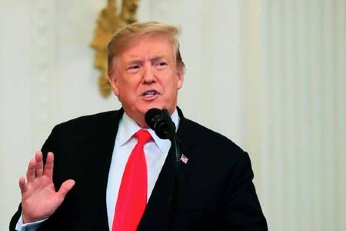 President Donald Trump speaks before awarding the Medal of Honor to Army Staff Sgt. Travis Atkins with Atkins’ son Trevor Oliver, 22, accepting the posthumous recognition for conspicuous gallantry in Iraq in June 2007, during a ceremony in the East Room of the White House, Wednesday March 27, 2019, in Washington. (AP Photo/Manuel Balce Ceneta)