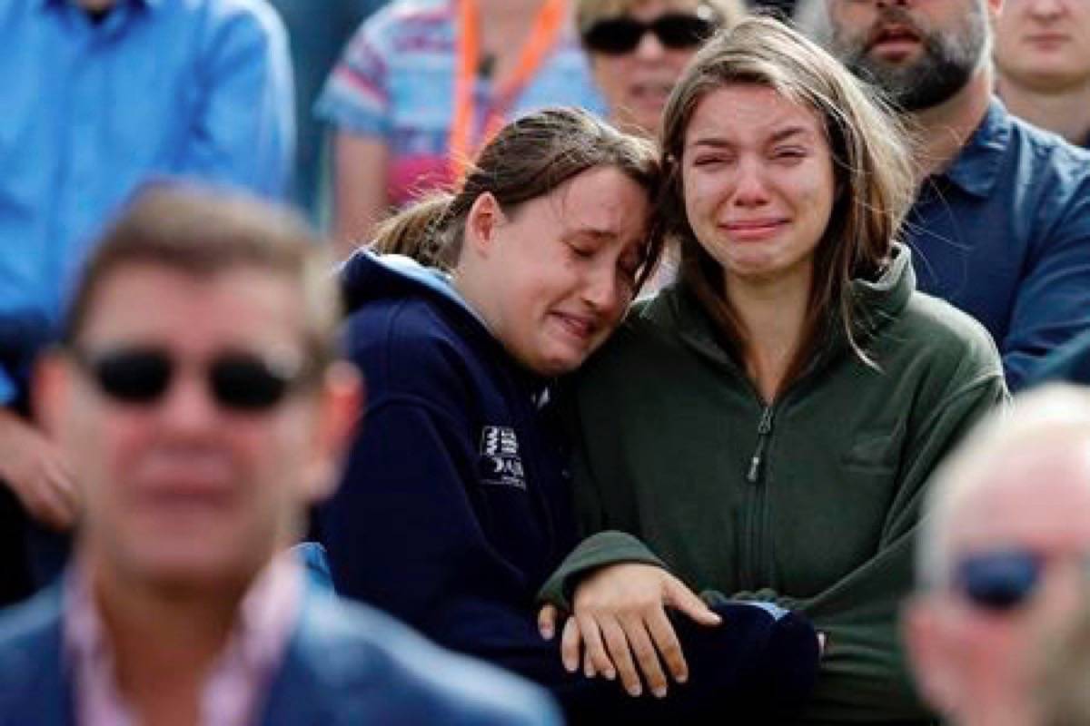 Women react as the New Zealand national anthem is sung during a national remembrance service in Hagley Park for the victims of the March 15 mosque terrorist attack in Christchurch, New Zealand, Friday, March 29, 2019. (AP Photo/Mark Baker)