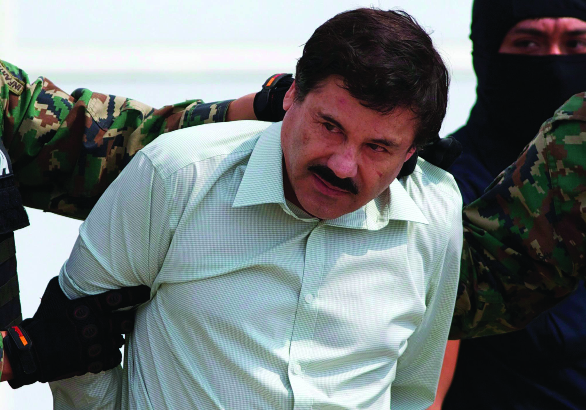 FILE - This Feb. 22, 2014 file photo shows Joaquin “El Chapo” Guzman, the head of Mexico’s Sinaloa Cartel, being escorted to a helicopter in Mexico City following his capture overnight in the beach resort town of Mazatlan. The lawyer for Guzman says his client’s mental health is deteriorating. Eduardo Balarezo told reporters on Tuesday, April 17, 2018, that he’s seeking a psychological evaluation for Guzman before he goes to trial later this year in federal court in New York. The lawyer spoke outside court following a pretrial hearing. (AP Photo/Eduardo Verdugo, File)